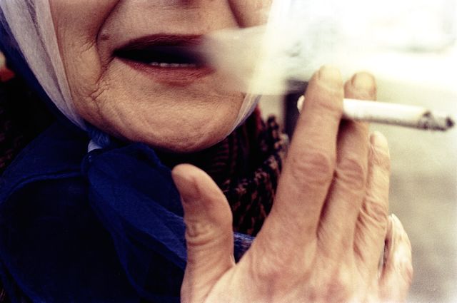 Woman with red lips smoking