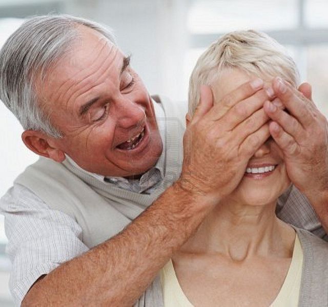 senior-couple-in-a-playful-mood- -husband-covering-wife-s-eyes