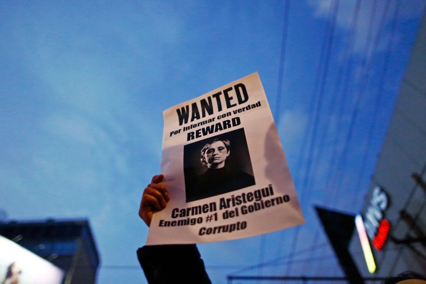 A demonstrator holds a sign during a protest against the dismissal of two investigative journalists from a news programme on MVS