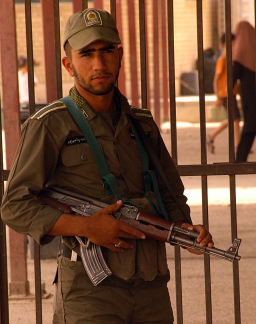 An Iranian soldier stands guard at the gate between Iraq and Iran on the edge of Wasit Province, Iraq, 2008
