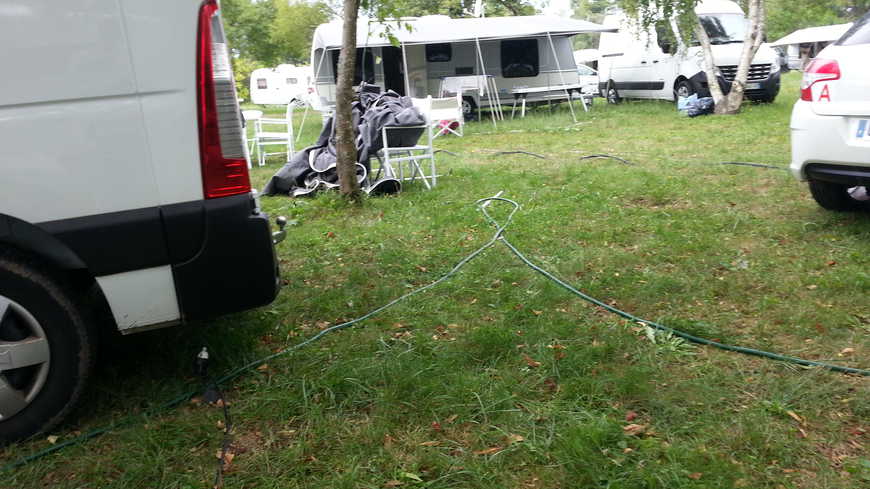 Les gens du voyage sont installés sur une grande pelouse du campus