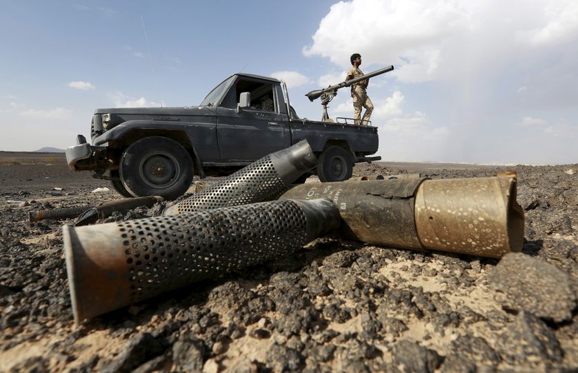 A fighter of the anti-Houthi Popular Resistance Committees stands on a truck during fighting with Houthi fighters near Yemen's n