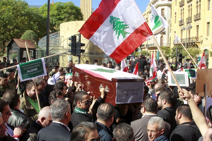 an empty coffin symbolizing the Constitution of Lebanon during a protest near the parliament building, where lawmakers are meeti