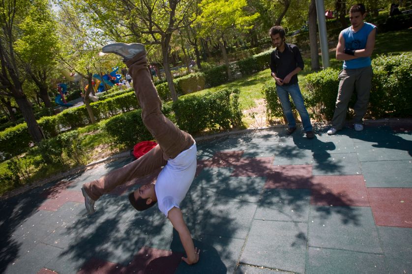 breakdances in a park in Tehran