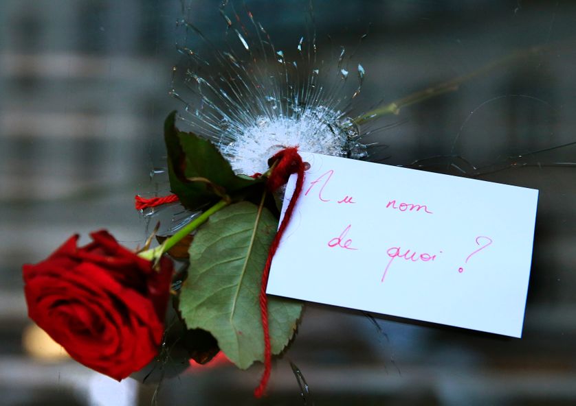 A rose placed in a bullet hole in a restaurant window the day after a series of deadly attacks in Paris.