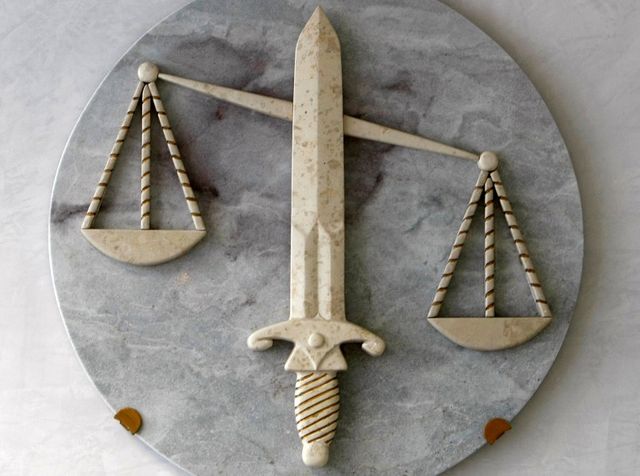 the symbol of justice, with the sword and the scales, is seen in a lawyers cabinet in nice