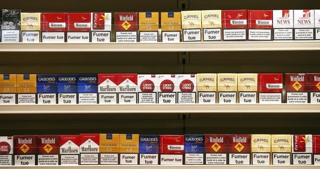 cigarette packs are presented in a simulated tobacconist shop at a news conference in paris