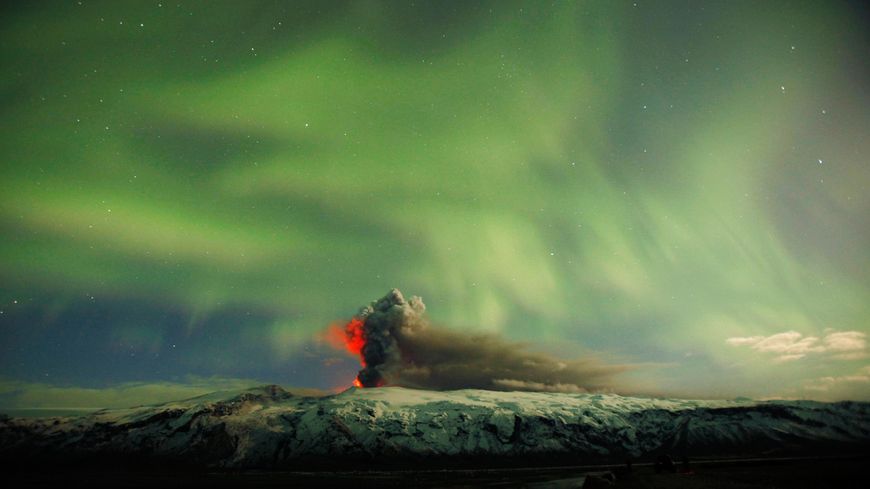 Aurore boréale au-dessus des cendres du volcan Eyjafjallajökull en éruption, en avril 2010.