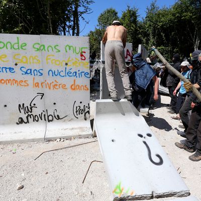 Des opposants au projet de stockage des déchets radioactifs de Bure (Meuse) détruisent un mur de protection du chantier, le 14 août 2016