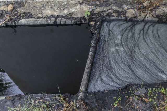L'eau qui circule dans les gouttières est pollué à l'extérieur de l'usine Aditya Jeans Washers, dans la zone industrielle Mundargi de Ballari, Karnataka, en Inde (mai 2016)