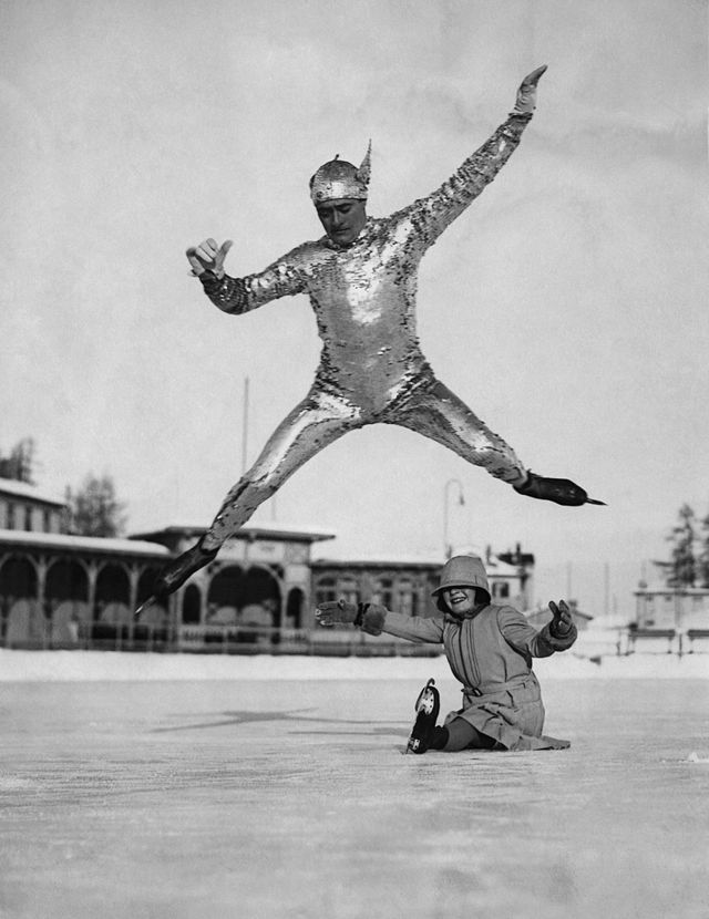 Le champion du monde de patinage Phil Taylor saute au-dessus de sa fille Megan sur la patinoire de l'hôtel Kulm à St. Moritz, en Suisse vers 1930