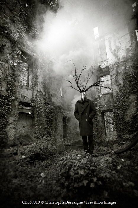Masked figure in abandonded yard