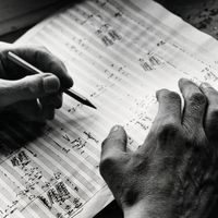 German composer Carl Orff (1895-1982) at work on score, 1949