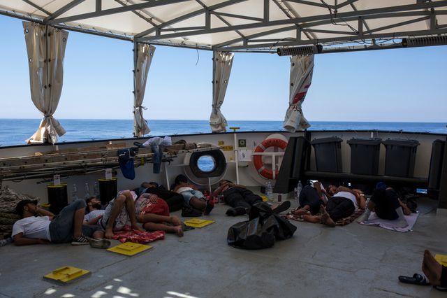 Des migrants libyens dorment sur le pont de l'Aquarius après leur sauvetage en Méditerranée, à 20 milles nautiques de la côte libyenne, le 2 août 2017.