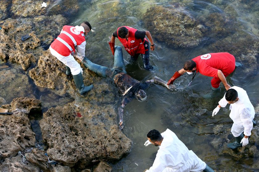 Des membres du croissant rouge libyen repêchant le corps d'un noyé, en périphérie de Tripoli, en juin 2017