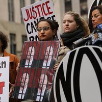 Une manifestante membre de la National Organization for Women (NOW) tient une pancarte représentant H. Weinstein sous des barreaux de prison, à New York, le 13 octobre 2017