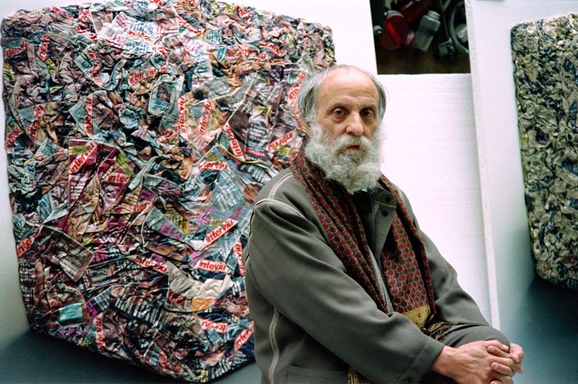 Le sculpteur César pose devant deux de ses compressions le 19 mars 1991 à Paris.
