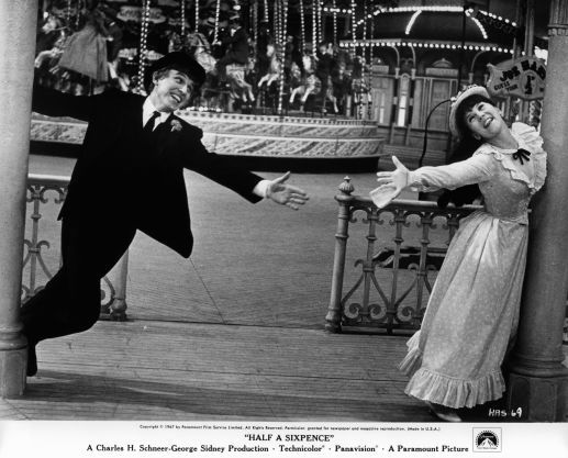 ommy Steele and Julia Foster reaching out to each other in a scene from the film 'Half A Sixpence', 1967