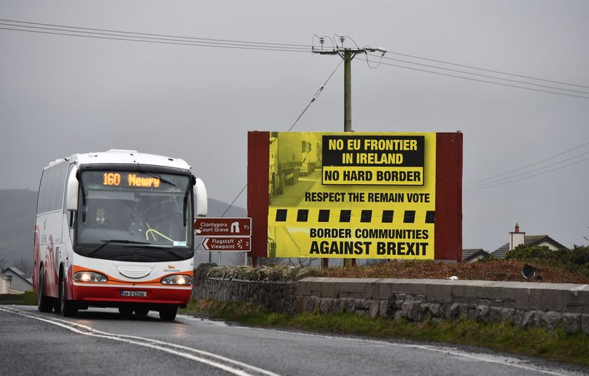 NEWRY, NORTHERN IRELAND - FEBRUARY 02: A bus crossing along the border between Northern and southern Ireland passes a sign campaigning against a so called hard Brexit, on February 2, 2017 in Newry, Northern Ireland.
