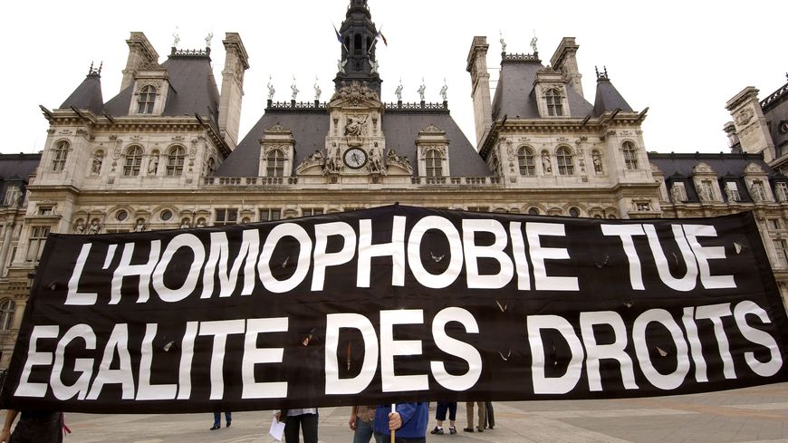 Des militants contre l'homophobie déploient une banderole, le 5 juin 2004 devant l'hôtel de ville de Paris, pour soutenir la démarche de Noël Mamère qui célèbre simultanément le mariage de deux homosexuels à Bègles.