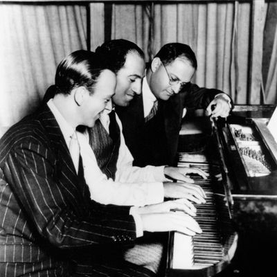 Shall We Dance Actor Fred Astaire (1899 - 1987) with composer and lyricist George and Ira Gershwin on the Hollywood set of the musical 'Shall We Dance', 1937