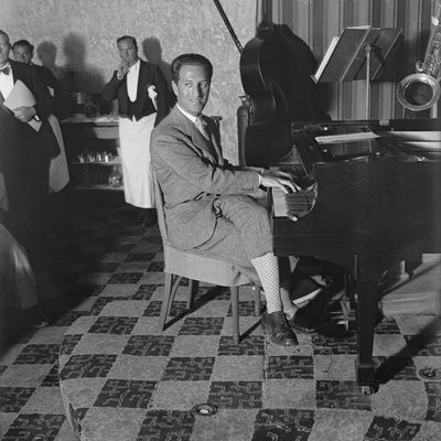 Gershwin Playing Piano (Original Caption) 2/19/1930-Miami Beach, FL- George Gershwin, foremost, present-day, music composer, is seen here at the piano, at the Deauville pool where he is vacationing.