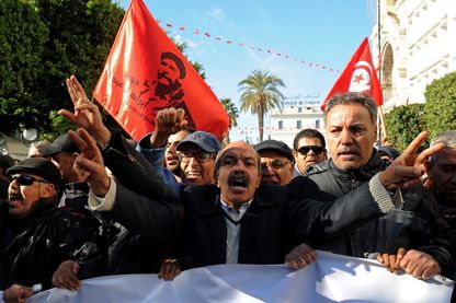 Janvier 2018, des travailleurs tunisiens crient des slogans contre le gouvernement devant le siège de l'Union générale tunisienne du travail (UGTT) à Tunis . Janvier 2018, des travailleurs tunisiens crient des slogans contre le gouvernement devant le siège de l'Union générale tunisienne du travail (UGTT) à Tunis .