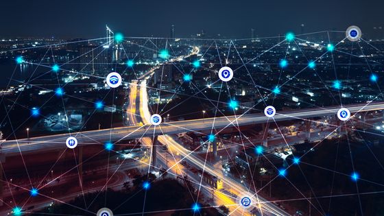 city at night with communication icons and network lines mix media concept background ©Getty - Busakorn Pongparnit
