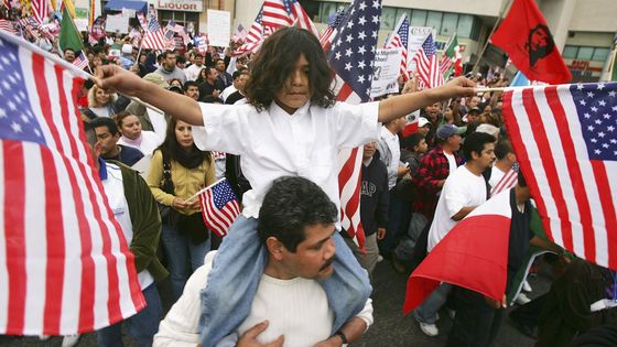 Ramirez Montes, 6 ans, sur les épaules de son père Gustavo, lors d'une marche pour appeler les législateurs à aider les immigrants illégaux à devenir citoyens le 10.06.2006 à Los Angeles, Californie (après 1 rejet du Sénat en faveur d'1 légalisation) ©Getty - David McNew/Getty Images