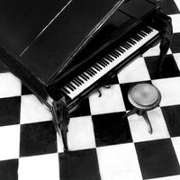 Overview of a grand piano on a checkered floor