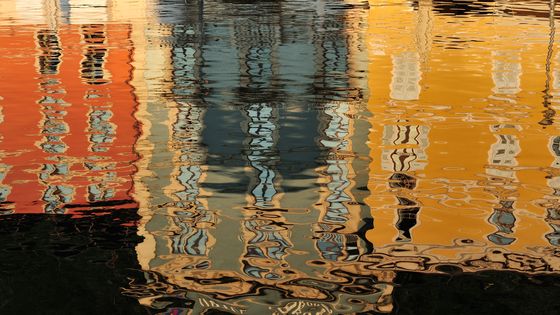 Buildings reflecting in the water of the marina, Riva del Garda, Lake Garda, Trentino-Alto Adige, Italy ©Getty - Albert Ceolan