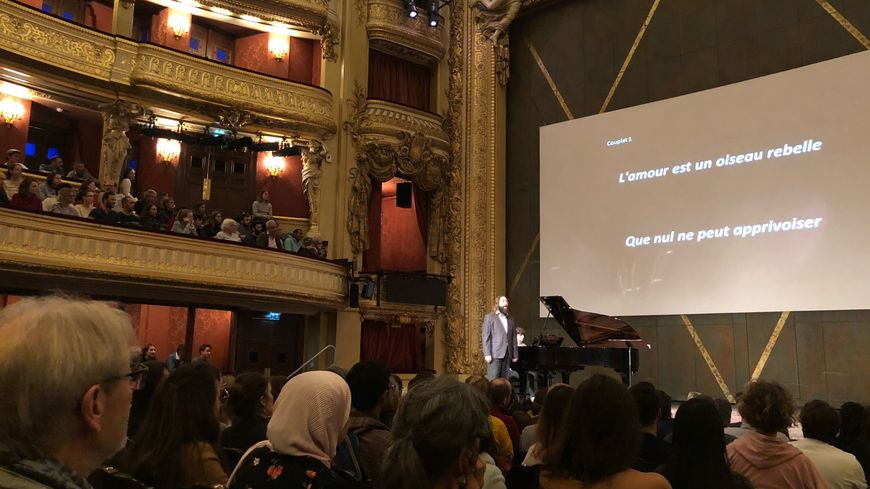 Le chanteur sur scène utilise surtout l'humour pour faire comprendre au public les nuances d'un chant d'opéra.