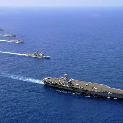 Military ships operate in formation in the South China Sea. - Photos