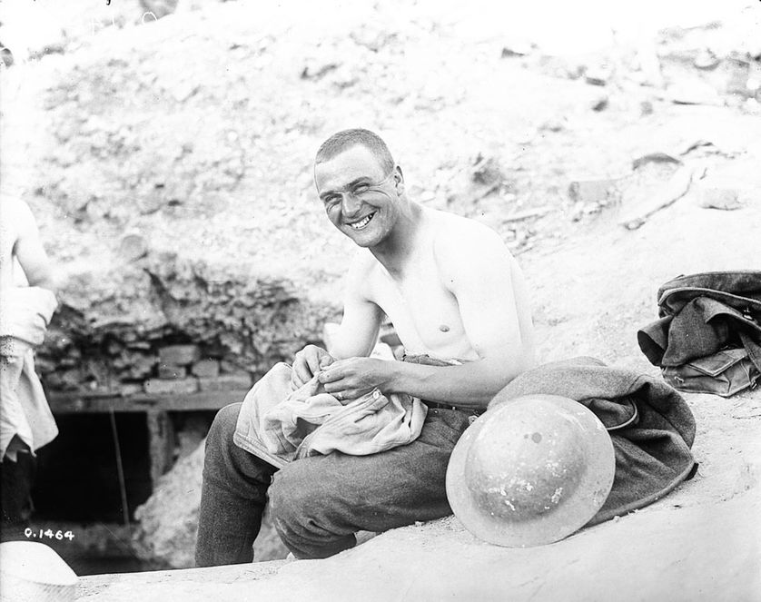 Canadien qui cherche des « cooties » (poux de corps) dans sa chemise en mai 1917.