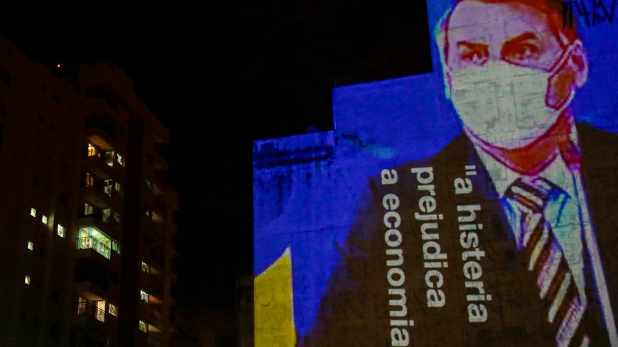 Une image de Jair Bolsonaro avec sa déclaration projetée sur la façade d'un bâtiment de Sao Paulo ("l'hystérie est préjudiciable pour l'économie"), le 21 mars 2020