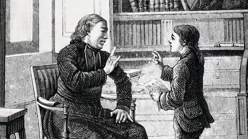 Charles-Michel de l'Épée apprend la langue des signes à un enfant sourd.
