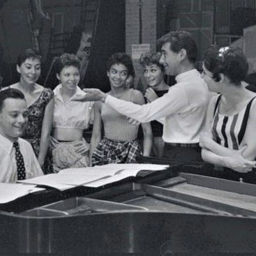 1957, Leonard Bernstein at rehearsal for "West Side Story" lyricist Stephen Sondheim is playing the piano, Carol Lawrence (Maria) is at his left