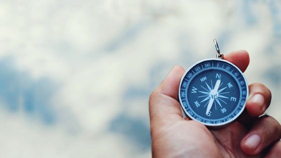 Close-Up Of Hand Holding Navigational Compass Outdoors ©Getty - Madcat Madlove / EyeEm