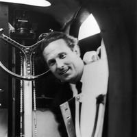 L'aviateur Jean Mermoz à la porte du poste de pilotage de son avion en 1937.