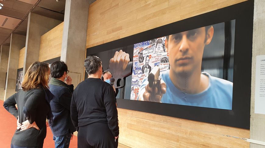 Antoine Guillot, Amos Gitai et Marie-José Sanselme devant l'image d'Yigal Amir, l'assassin de Yitzhak Rabin, dans l'exposition "Yitzhak Rabin / Amos Gitai" présentée à la BNF jusqu'en novembre 2021
