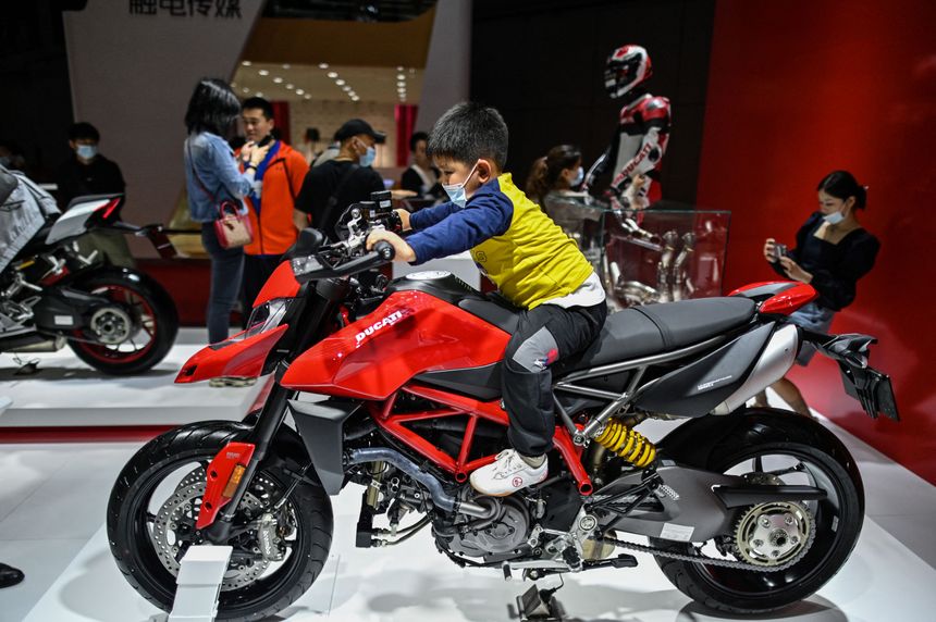Un enfant essaie une moto Ducati, mrcredi 21 avril, premier jour d'ouverture au public du Salon.