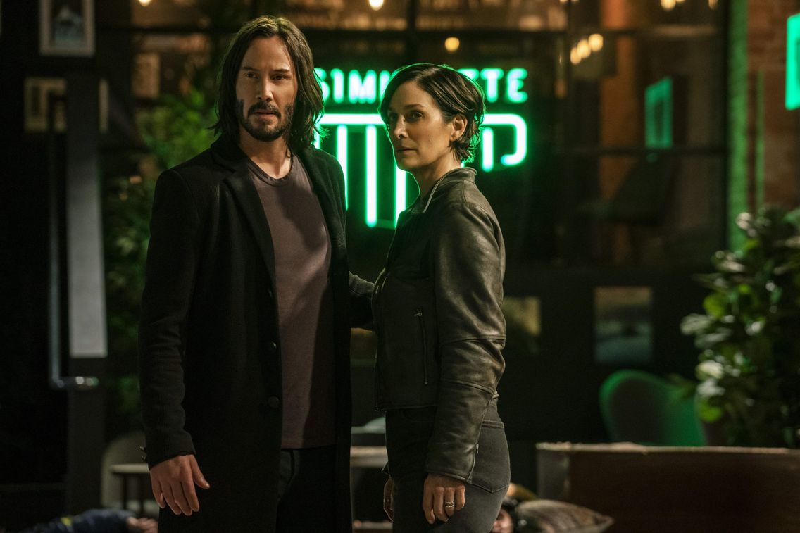 Keanu Reeves and Carrie-Anne Moss in the latest Matrix movie, released December 22.
