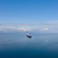 Vue aérienne du grand cargo simple sur la mer au-dessus du ciel bleu ensoleillé