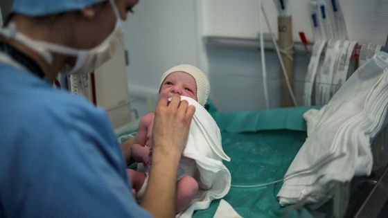 A midwife cleans a baby just after his birth on March 29, 2017 at the maternity department of Lyon's Croix-Rousse hospital. ©AFP