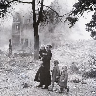 Une mère et ses enfants au milieu des décombres fumants de leur ville après un bombardement nazi