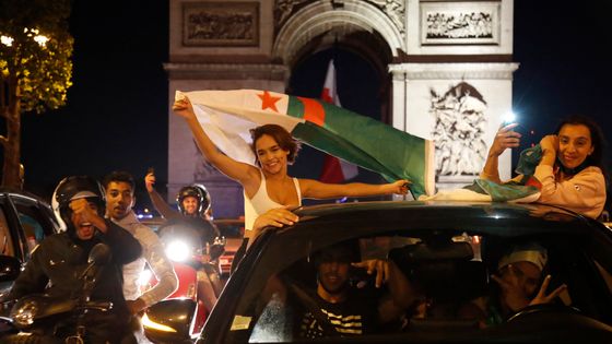 De jeunes supporters de l'Algérie célèbrent la victoire de l'Algérie en 2019 à la CAN sur les Champs Elysées; Paris, 14 juillet 2019. ©AFP - Zakaria ABDELKAFI / AFP