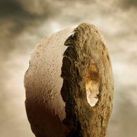 Stone wheel against clouds