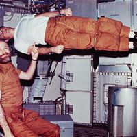 Floating in Zero-G : astronaut Gerald P. Carr seems to hold up fellow astronaut Edward G. Gibson with his finger.