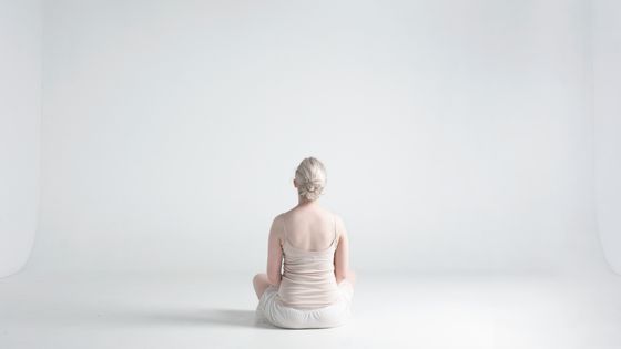 Femme assise de dos les jambes croisées. ©Getty - Tara Moore