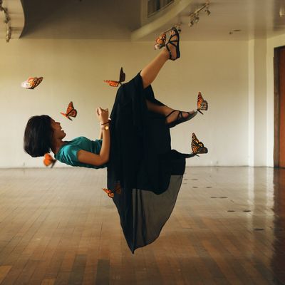 Optical Illusion Of Butterflies Holding Girl In Mid-Air At Room